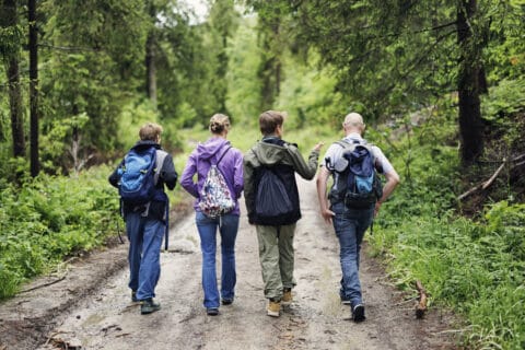 Father and teenage kids hiking during retreat